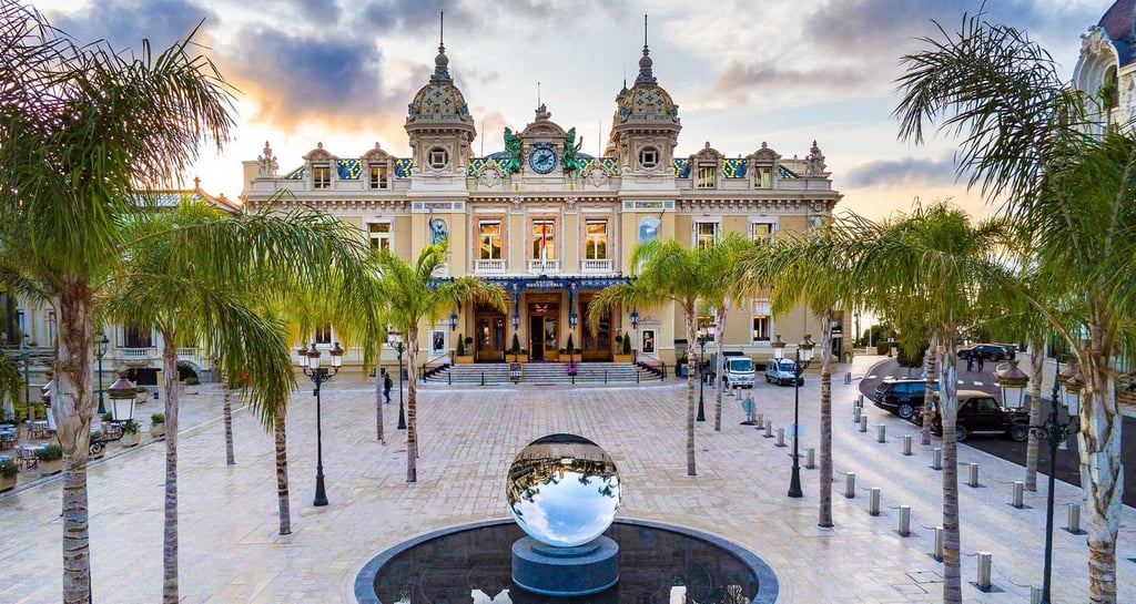 a fountain with a statue of a man in front of a building