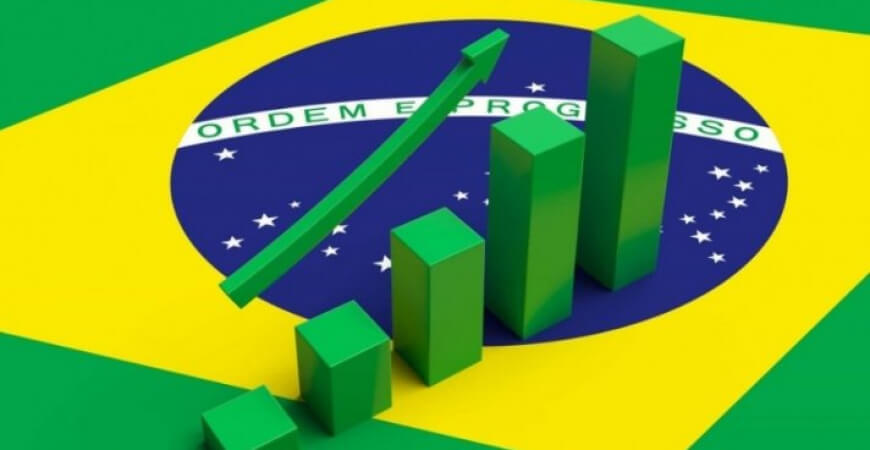 imagem mostra um gráfico financeiro estampado em cima da bandeira do Brasil.