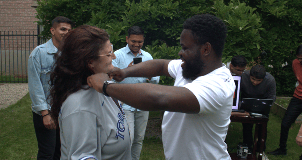 a man and woman dancing in a yard