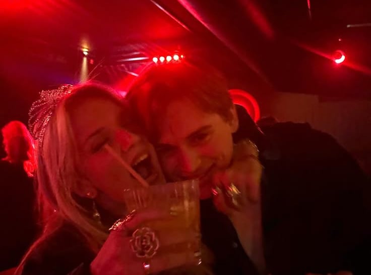 a couple is posing at the bar