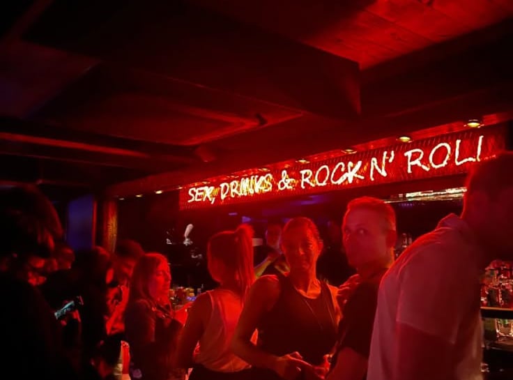 a group of people standing in a bar