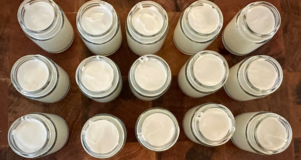 glass jars full of essential oil hand cream in the process of being made