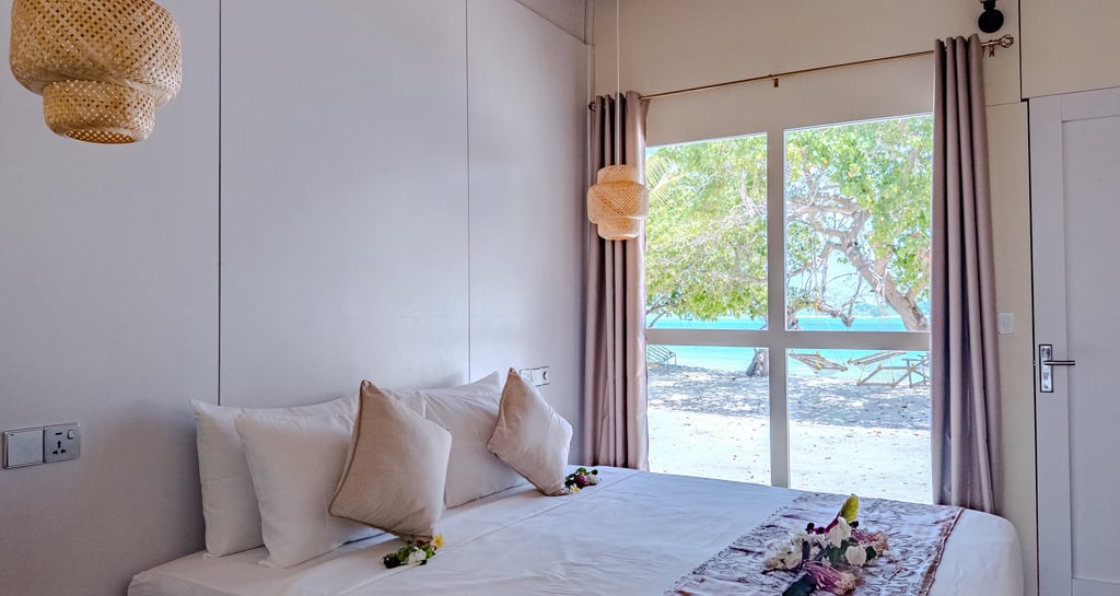 Modern beachfront bedroom at a boutique guest house in Maalhos, Baa Atoll, Maldives, featuring ocean