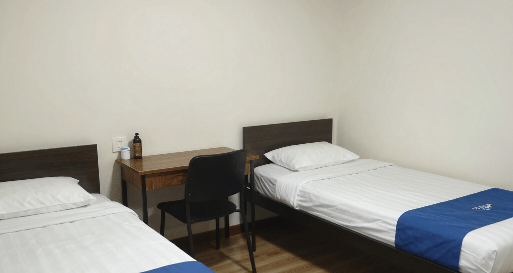 Cozy employee room with modern furnishings and a large window letting in natural light.