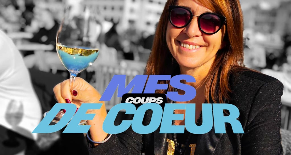 a woman holding a glass of wine in front of a crowd