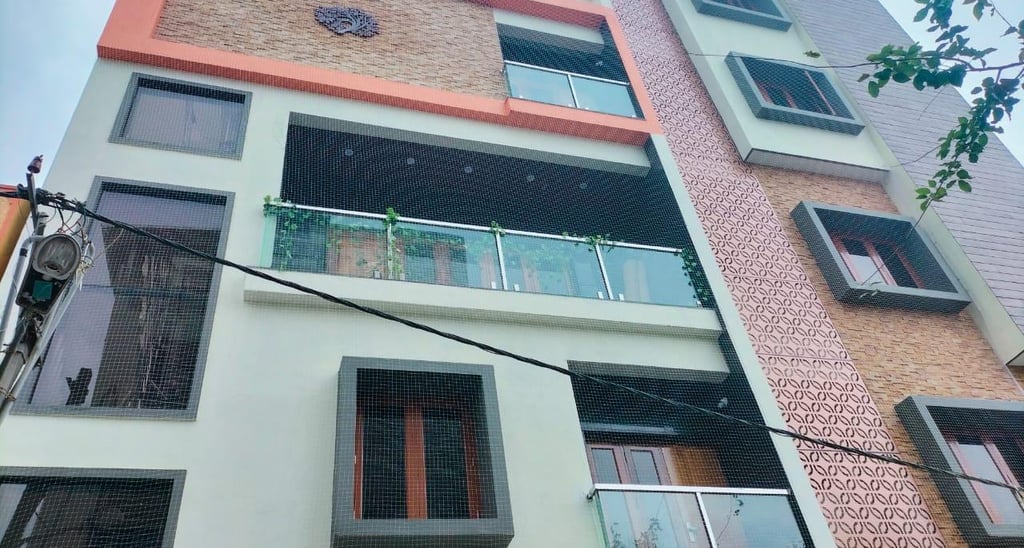 Close-up of a securely installed balcony safety net on a residential building in Egmore, Chennai.