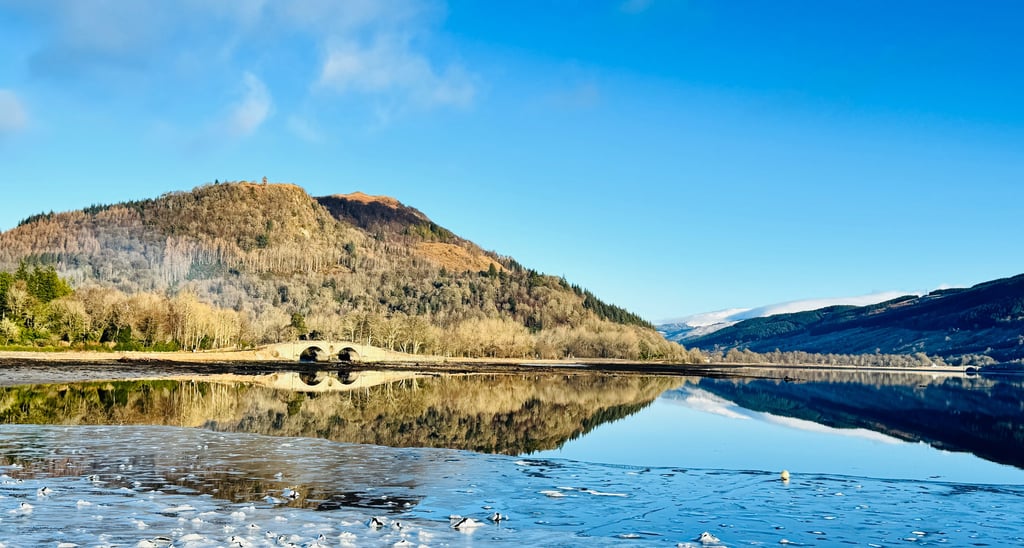 Loch Fyne in Inveraray with the Inveraray bridge and hills in the backgound.