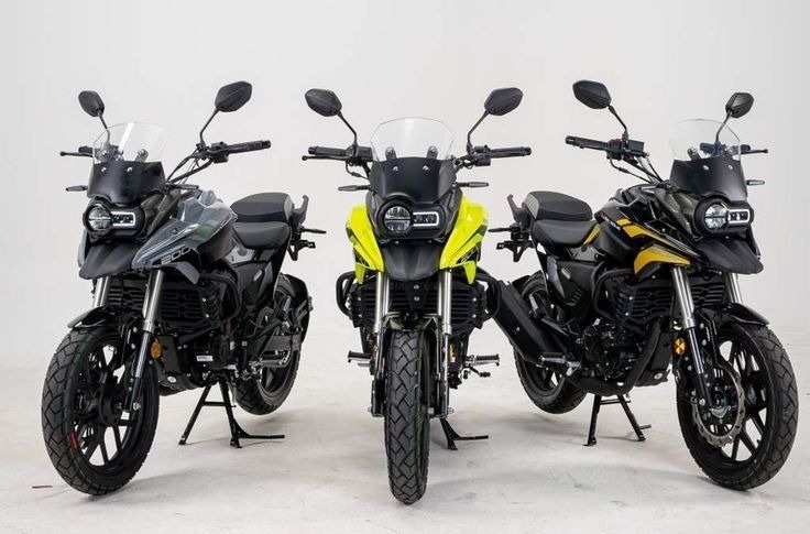 three motorcycles parked in a row on a white background