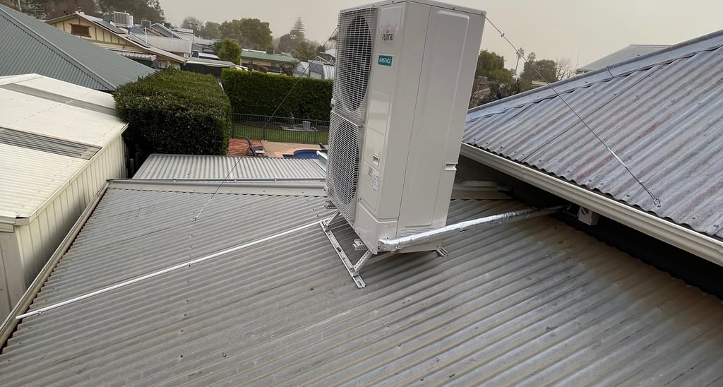 Fujitsu 20kW ducted reverse cycle air conditioning outdoor unit on roof bracket