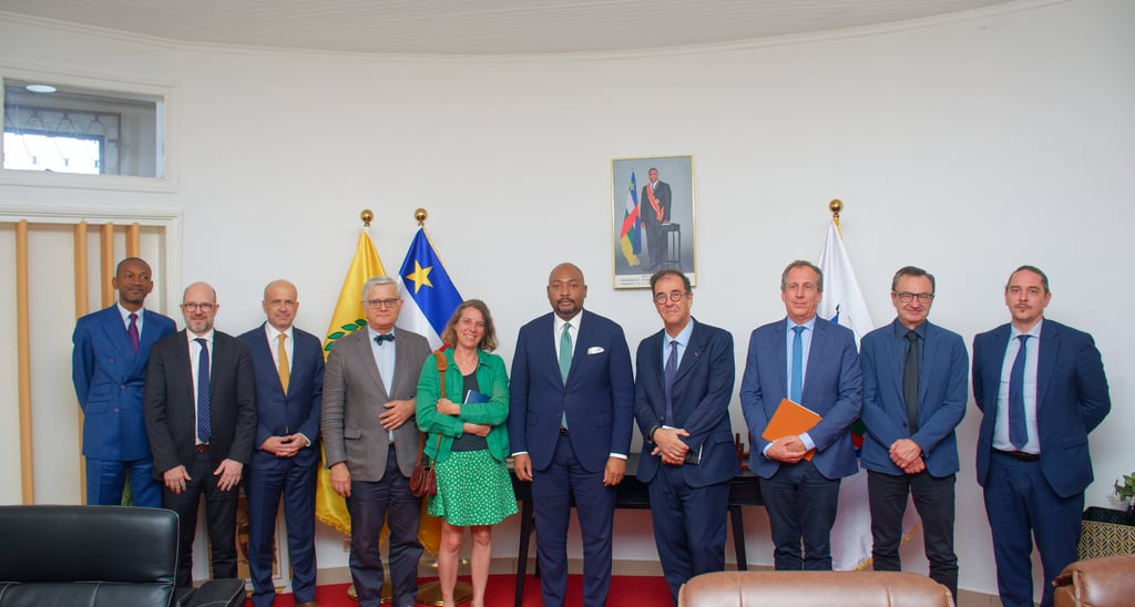 Professional group portrait of international delegates standing together for a formal diplomatic meeting.