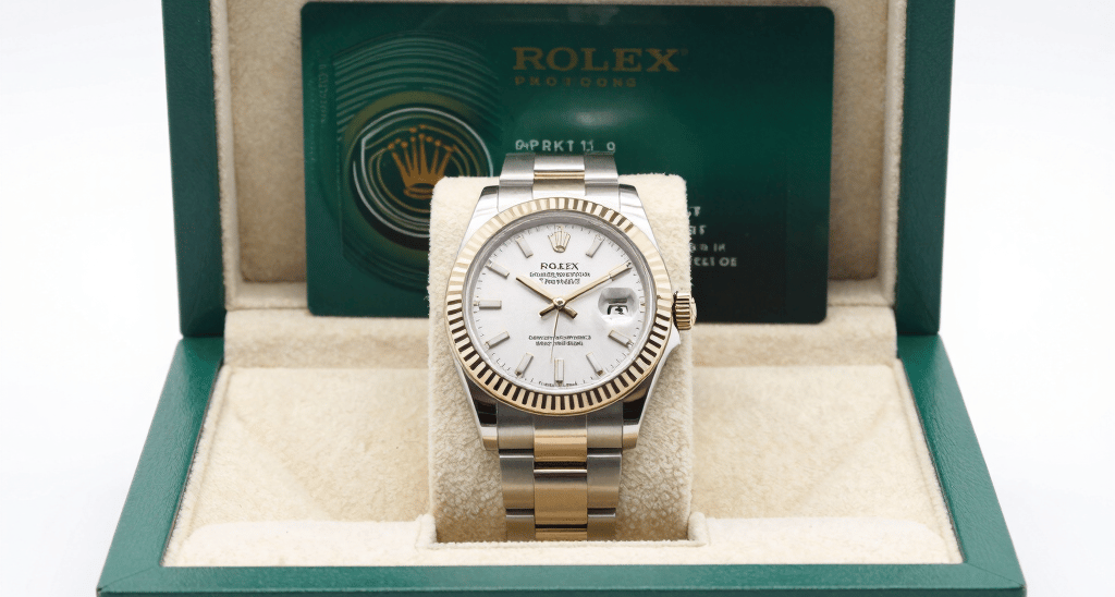 Close-up of a vintage silver necklace with intricate details resting on a velvet cloth.