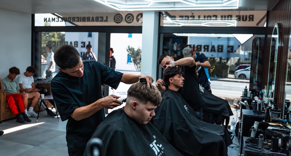 a man getting his hair cut by a barbershop