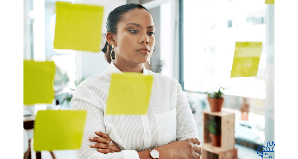 a woman standing looking at her strategy and reflecting to adjust accordingly