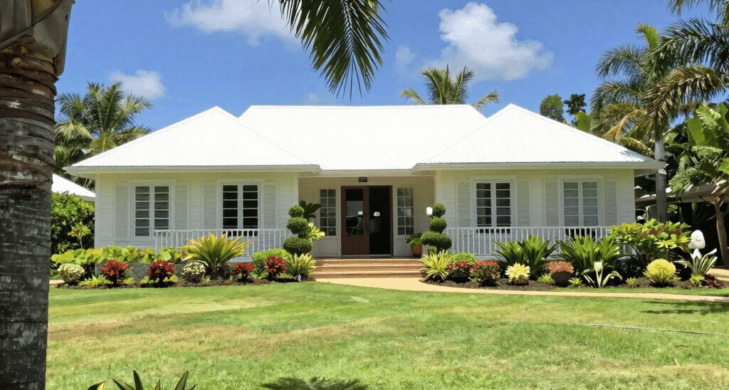 Lush tropical garden before landscaping with overgrown grass and scattered debris.