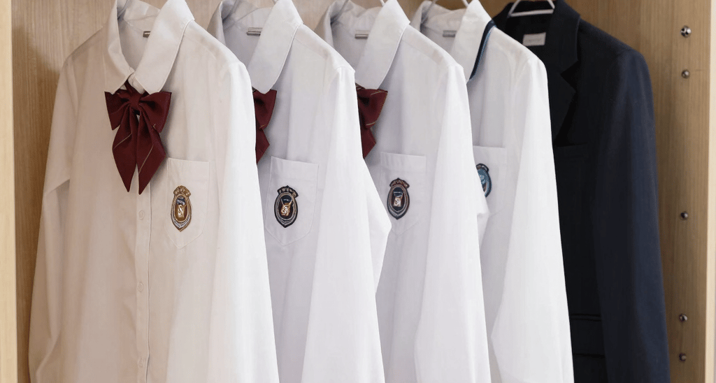 A vibrant display of Wonder Wings MySchool Kit uniforms neatly arranged on hangers, showcasing the bright colors and quality fabric.