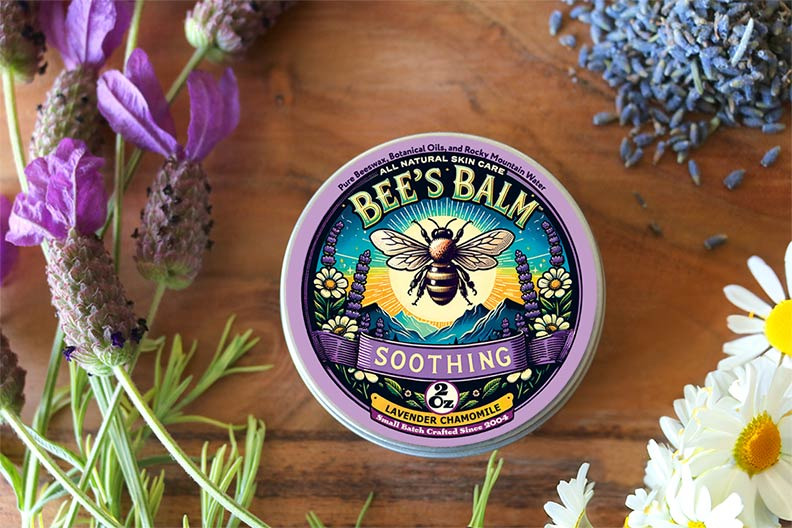 Soothing Bee's Balm tin surrounded by Lavender and Chamomile flowers