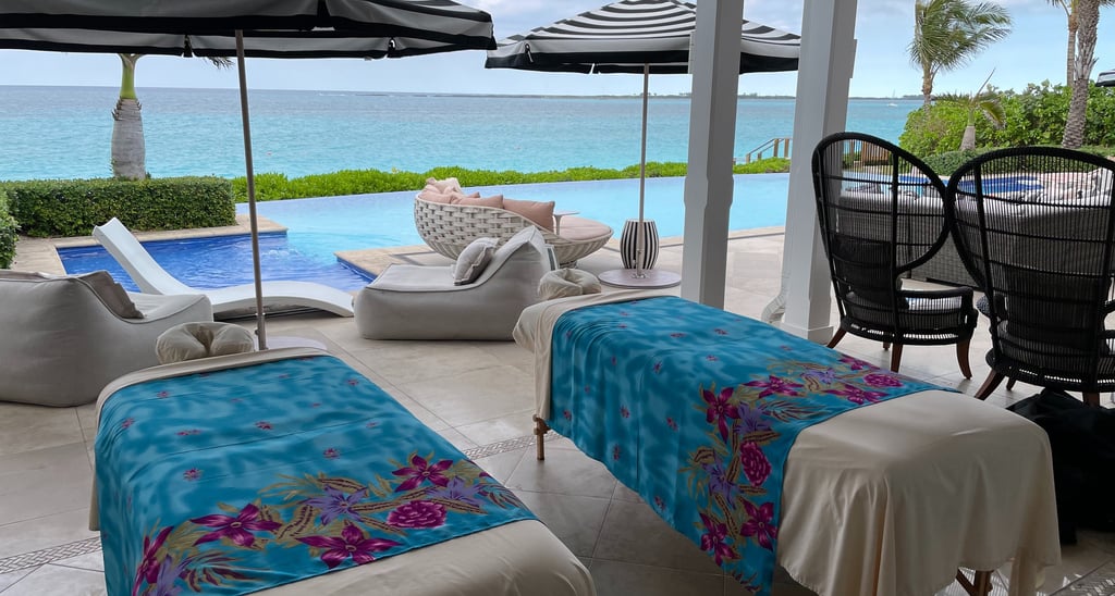 a couple of massages by sophia beds outdoor by a pool and ocean view
