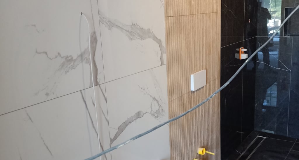 Modern minimalist interior staircase with grey walls, geometric architecture, and framed wall art.