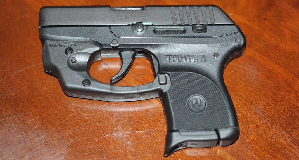 Ruger LCP with laser laying on a wood table