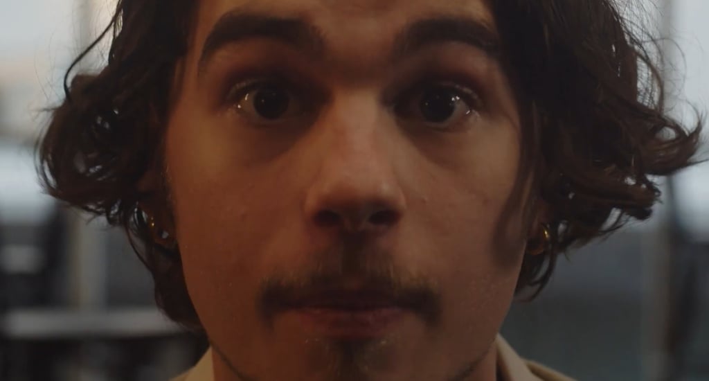a man with a mustache and a tie on his neck