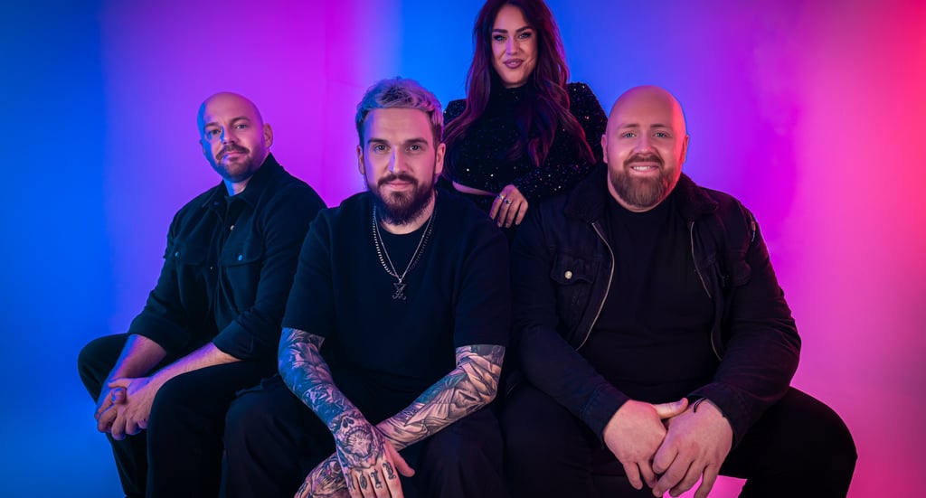a group of people sitting on a bench in front of a colorful background