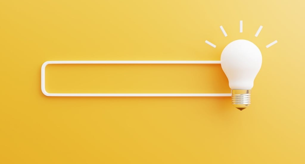a light bulb bulb sitting on top of a white light bulb - Illford Academy