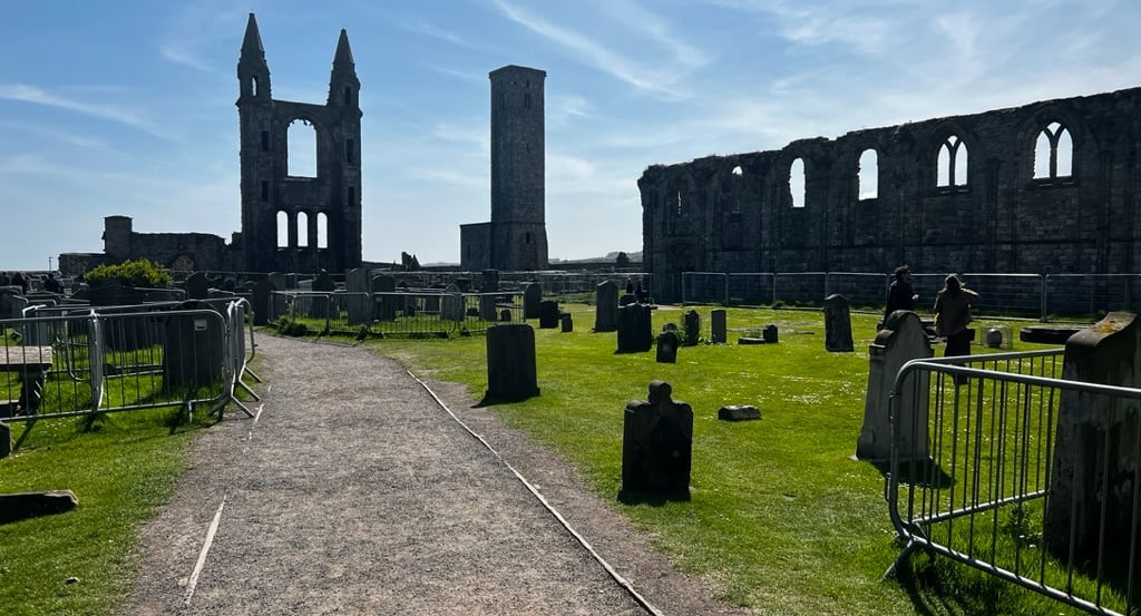 a cemetery with a church ruins and a tower