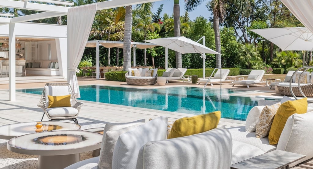 Pool area at Villa Serenity featuring modern furnishings, sunbathing lounges, and chill-out areas
