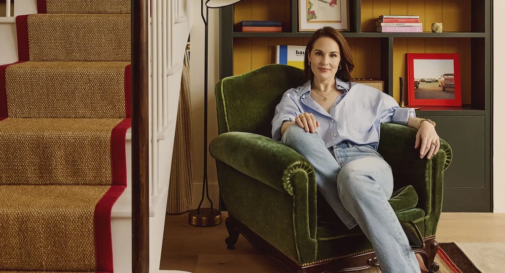 Michelle Dockery sitting in cozy armchair at home.