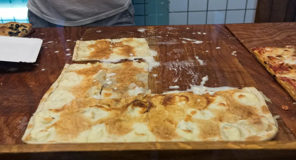 Close-up of freshly baked Focaccia di Recco with melted cheese oozing out