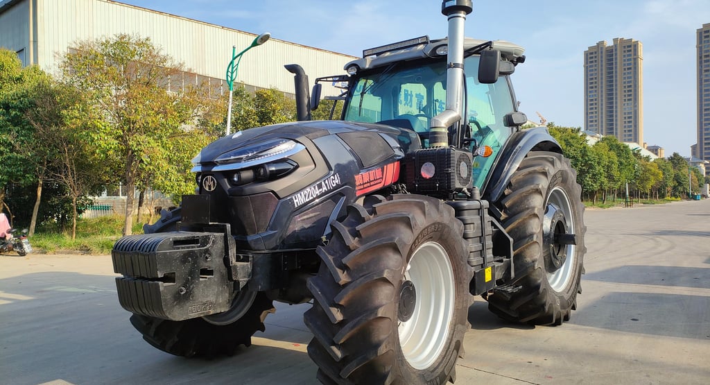 a tractor with a large tire on the side of the road