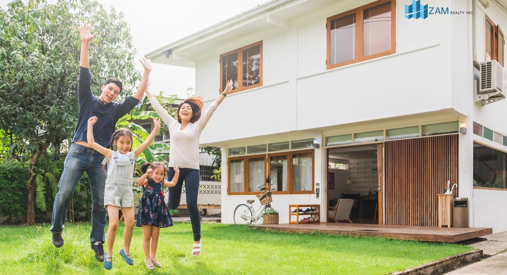 a family of four children jumping in the air near their huse in zambales