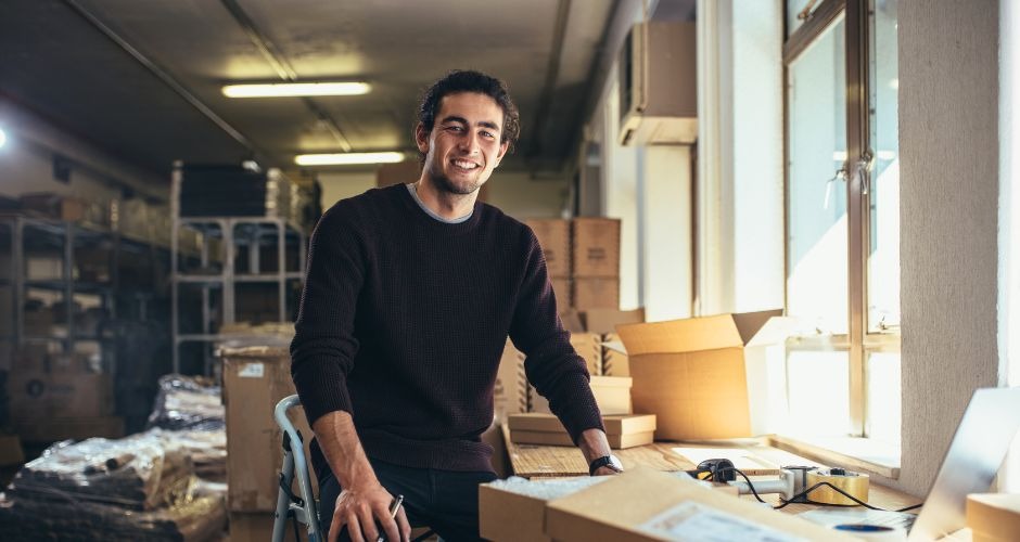 A man standing in a room with boxes of boxes