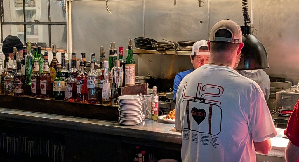 kitchen with chefs and waiter