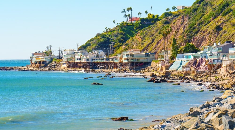 Stunning stilt houses perched at the water's edge on Malibu Beach, California.