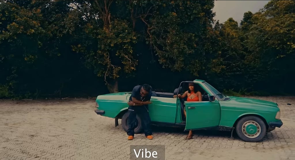 EazyKayy a man and woman in a red dress sitting in a green car