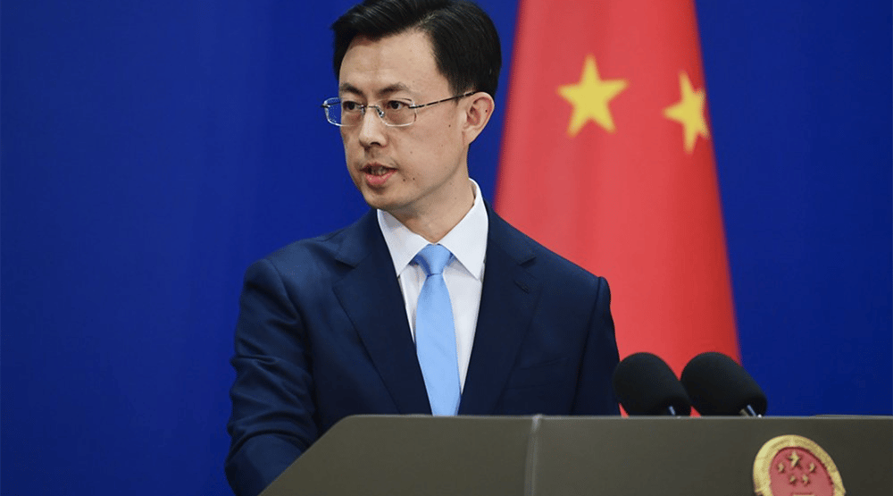 a man in a suit and tie standing at a podium