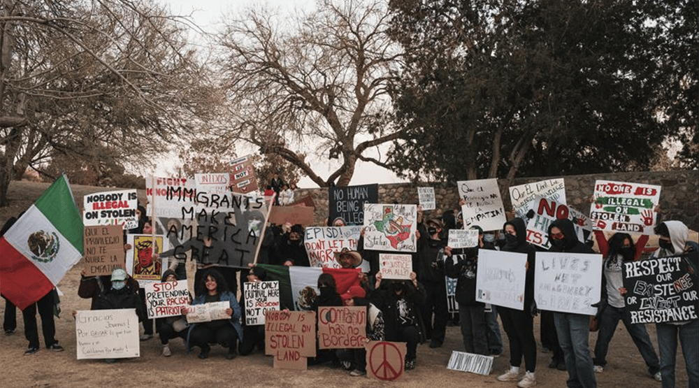 a group of people holding up signs and holding up signs