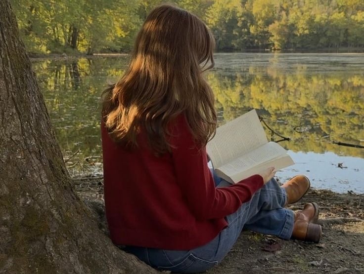a woman sitting on a tree trunk trunk trunk trunk trunk trunk trunk trunk trunk trunk
