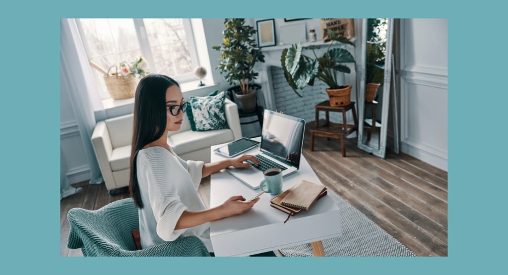 Female working from home with laptop in beautiful calm environment.