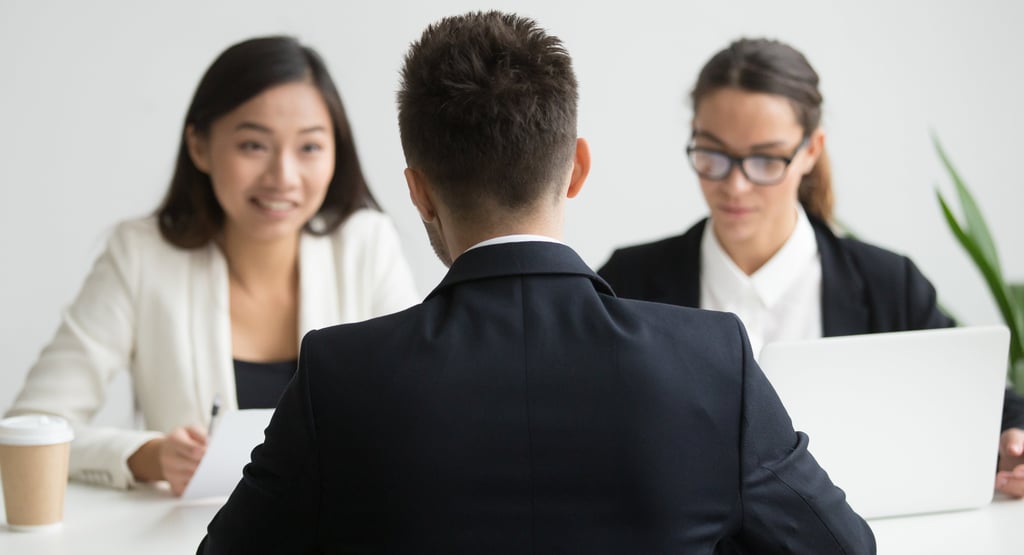 Male candidate interviewed by diverse HR team