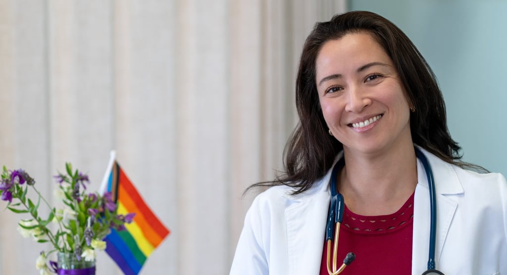 Dr Shannon Connolly in a white coat at the front desk of Open Arms Primary Care