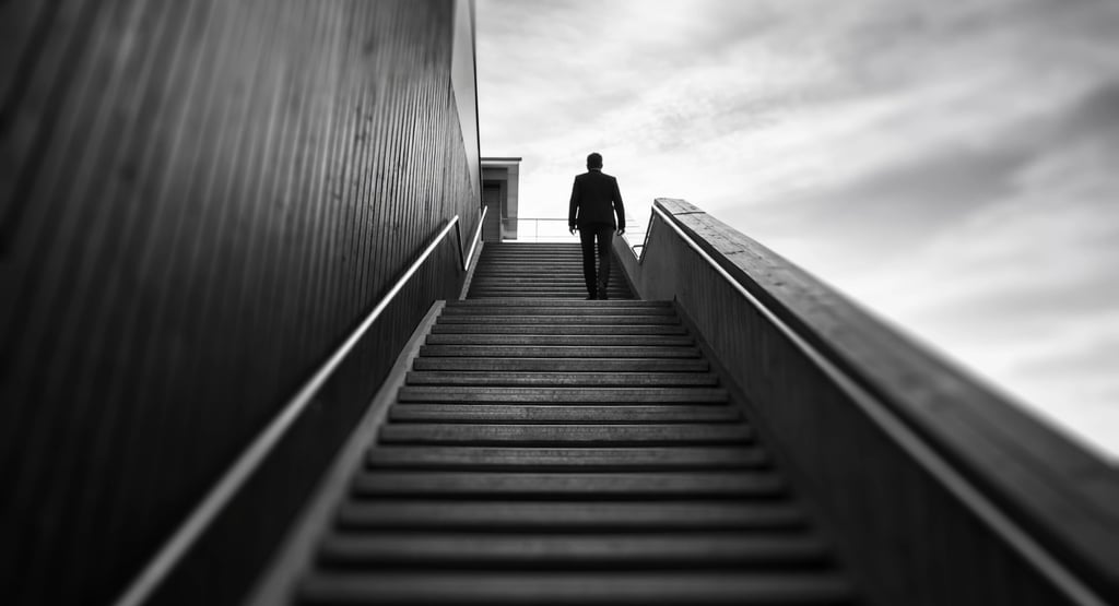 looking up at a man climbing a staircase