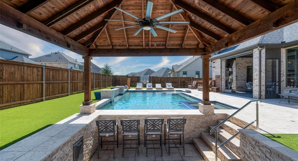 Pool kitchen with a pergola and view to the pool. Estrada Fencing & Outdoors