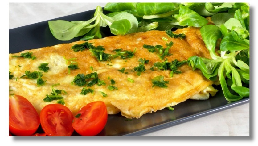 Savory omelette with aged cheese and Parma ham — simple, protein-rich Mediterranean breakfast.