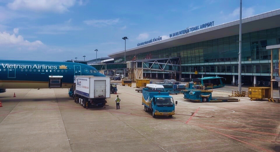 Passenger aircraft at Da Nang airport being serviced by ground crew