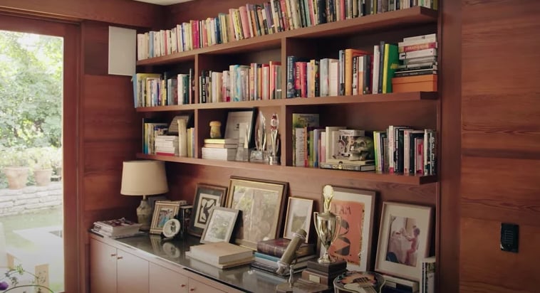 Dakota Johnson bookshelf study interior at home.