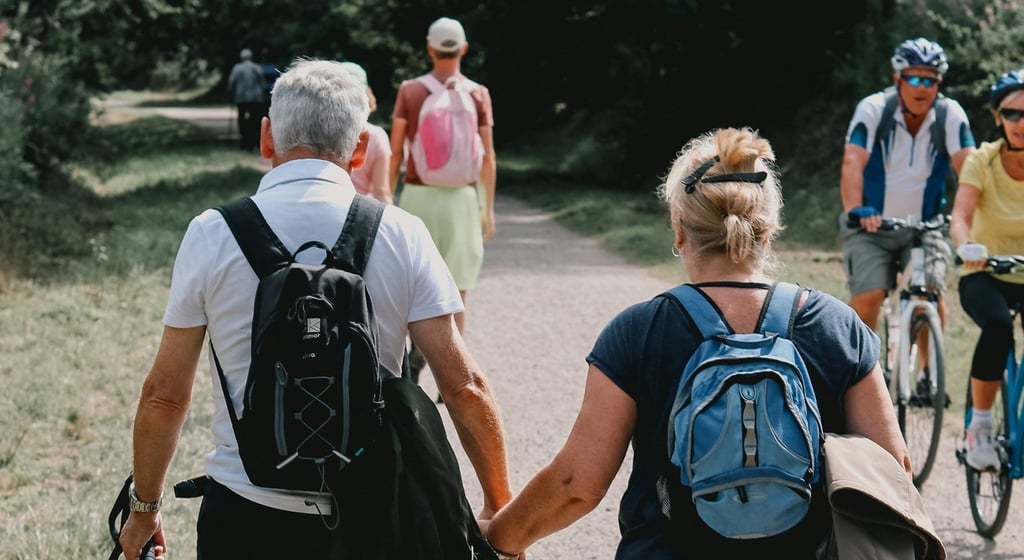 Older adults hiking together on a forest trail