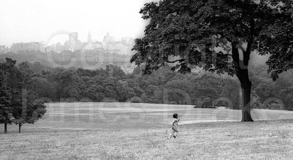 A child runs on Belmont Plateau in Philadelphia in the 1960s by James Drake