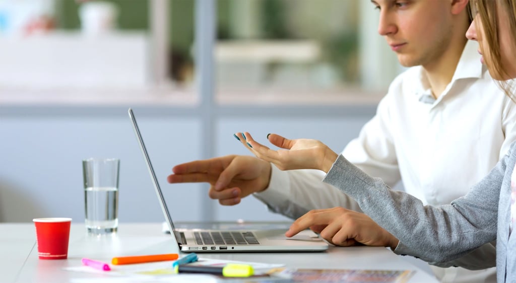 Male and Female Website Designers with Laptop